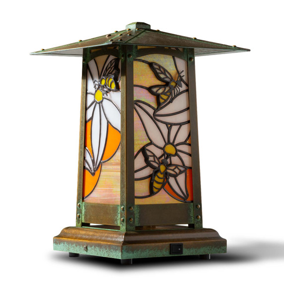  An Asian architecture inspired battery powered table lamp with an orange blossom and honey bee stained glass panel design. 