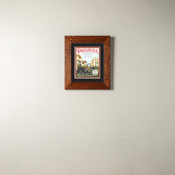  A print of a painting commemorating the anniversaries of Route 66 and Colorado Boulevard in Pasadena, California. It is in an oak frame.
