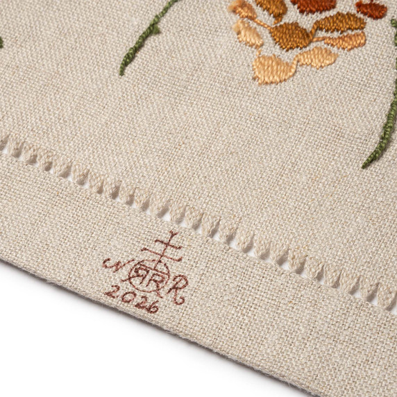  Close-up of brown Roycrofters maker's monogram mark and date on natural linen fabric pine cone table scarf.