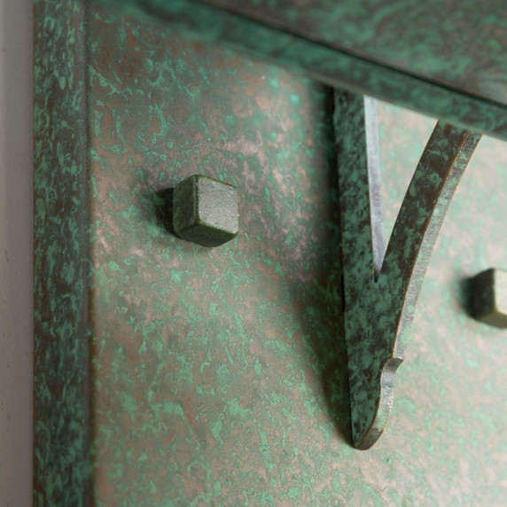  Detail of a rustic, artistic wall mounted light fixture with Japanese Maple artwork, an aged verdigris finish and golden glass.