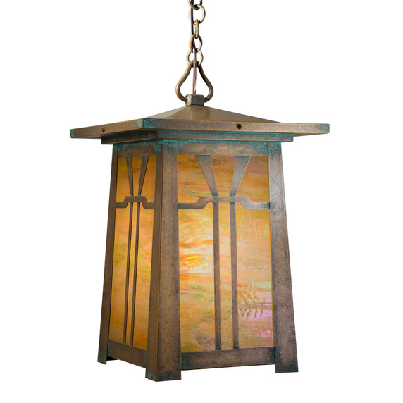  An Arts & Crafts chain mounted pendant light fixture with an aged patina brass finish, iridescent glass and a Gamble House design.