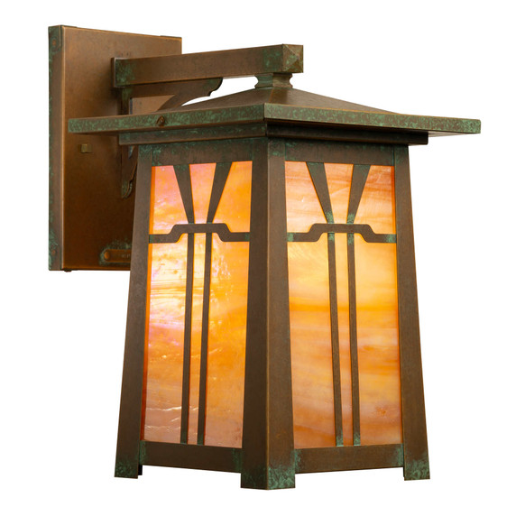  An Arts & Crafts wall mounted sconce light fixture with an aged brass finish and golden glass.