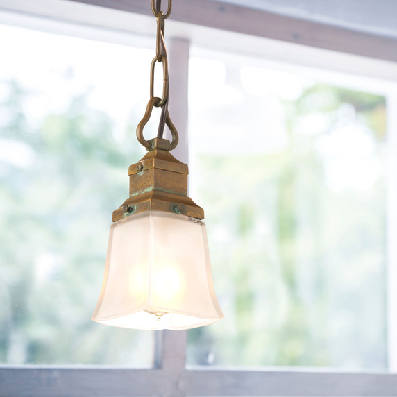  A traditional Mission or Craftsman style frosted white glass shade with a linear body and square rim. It has a round, 2.25