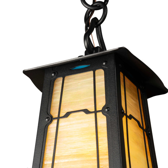  Detail of a playful, chain mounted pendant lantern with colorful accent glass, a cloud lift overlay pattern, satin black finish and golden glass.