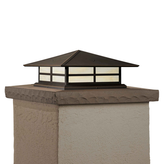  A Prairie Style column mounted pier light fixture with a window pattern, bronze finish and creamy white glass.