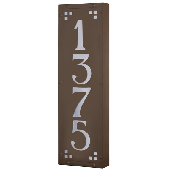  A solid brass, vertically oriented illuminated house number plaque with a four number address, a smooth bronze finish, white glass and corner glass accents.
