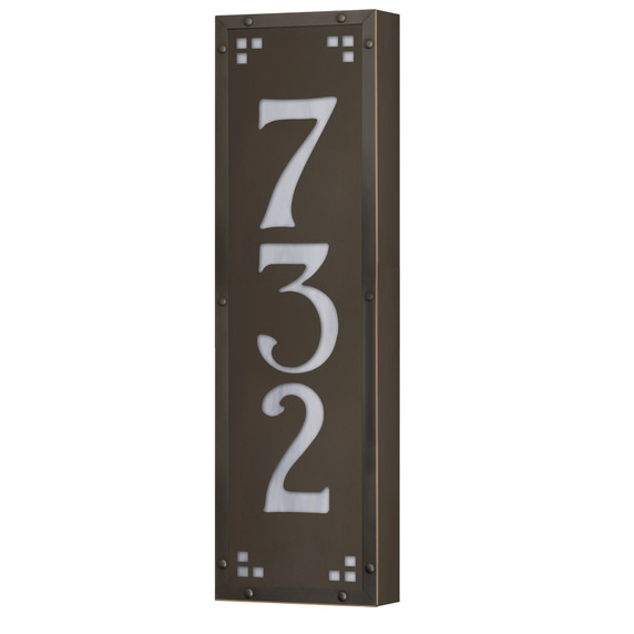  A solid brass, vertically oriented illuminated house number plaque with a three number address, a bronze finish, white glass and corner glass accents.