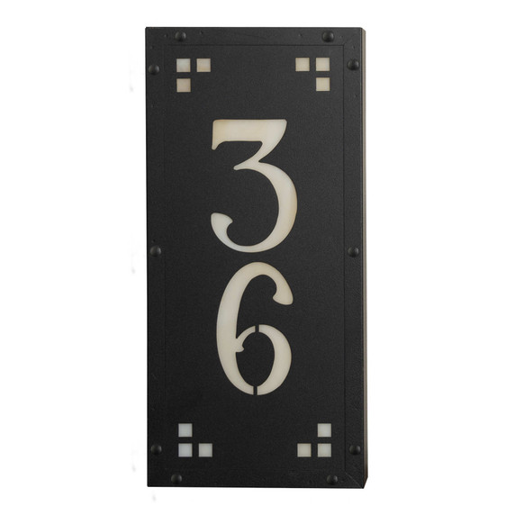  A solid brass, vertically oriented illuminated house number plaque with a two number address, a satin black finish, warm-toned glass and corner glass accents.