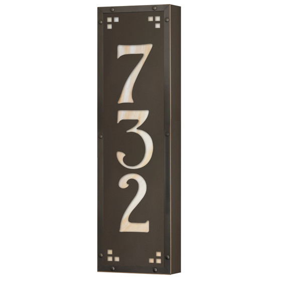  A solid brass, vertically oriented illuminated house number plaque with a three number address, a bronze finish, warm glass and corner glass accents.