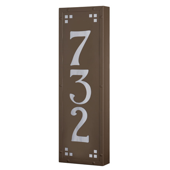  A solid brass, vertically oriented illuminated house number plaque with a three number address, a smooth bronze finish, white glass and corner glass accents.