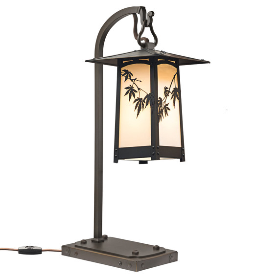  A rustic, artistic table lamp on a hooked arm. The lantern has a peaked roof, Japanese maple artwork, an oil-rubbed bronze finish and warm white glass.