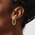 Image of 25.2mm 14K Yellow Gold Polished Textured Twisted Oval Hoop Earrings