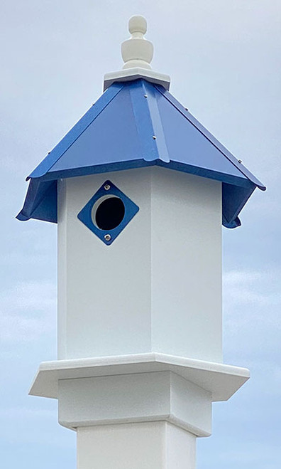 Wing & A Prayer Bluebird Hexagonal House, Cobalt Blue Roof
Highlight vivid colors, lasting materials, and your love of birds by adding this Wing and A Prayer Bluebird Hexagonal House with Cobalt Blue Roof to your yard. Placing this six sided unit within your landscaping provides small songbirds a welcome rest, and lends a bright look to the area. The 1.5" diameter entry hole sits high on the white, PVC body, creating a deep nest box design that helps keep bluebird or other nestlings safe from predators. The hexagonal roof and extended base plate further the geometric hint, and a top, wooden finial completes the piece. The blue finish on this PVC roof, its metal tines, and the metal guard around the entry hole lend wonderful, jewel tones to the unit, and the finial removes from the roof for nest checks. Slide the attached mounting collar over a true 4" x 4" post to situate this shelter at a great height for your feathered friends. The PVC lumber construction remains lovely without peeling, rotting, or delaminating, and the white and blue colors make a bold statement with ease. Adorn your garden with a dynamic new roosting spot using this Bluebird Hexagonal House with Cobalt Blue Roof. Made in the USA.

Opening: 1.5" dia.
Dimensions: 8.75"L x 10.25"W hexagonal base x 18"H
Mounting: mount on 4" x 4" post
Construction: PVC, metal, wood