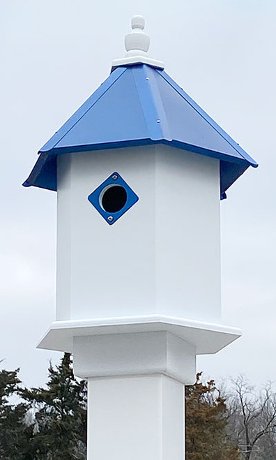Wing & A Prayer Sycamore Bird House, Cobalt Blue Roof
Provide lasting protection and shelter for two small songbird families by adding this Wing and A Prayer Sycamore Bird House with Cobalt Blue Roof to your backyard sanctuary. The bright color scheme and contemporary materials combine to form a durable nesting site, while creating a bold statement in your landscaping. The white, hexagonal PVC body has plenty of room for two avian families, and dual, 1.5" diameter entry holes on opposite sides of the shelter provide passage to wrens and chickadees. A deep blue, metal plate surrounds each entry hole, preventing woodpeckers and other birds from enlarging them, and each rests near the roof for a deep nesting area. The hexagonal, PVC roof keeps the interior dry and warm for your feathered friends, and its classic blue finish and metal tines lend extra angles and visual interest. An extended, bottom platform creates perching area, and the top, wooden finial brings height to the unit. This topper can also be removed for seasonal nest checks, and its white color matches that of the shelter. Slide the bottom mounting collar over a true 4" square post for a convenient and lasting display. The PVC body and roof ensure style and longevity, without peeling, rotting, or delaminating from exposure to the elements. Bring a bit of divine style and vivid colors to your bird garden with this Sycamore Bird House with Cobalt Blue Roof. Made in the USA.

Openings: 1.5" dia.
Dimensions: 9.75"L x 11.25"W hexagonal base x 19.75"H
Mounting: mount on 4" x 4" post
Construction: PVC, metal, wood