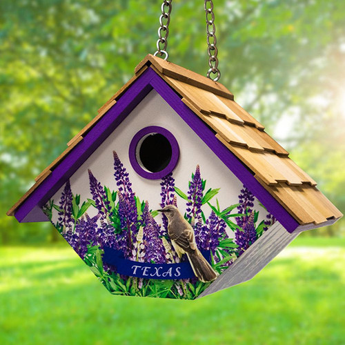 Home Bazaar Mockingbird & Bluebonnets Texas Wren House
Celebrate beautiful, natural scenery while honoring the great state of Texas in your backyard space when you showcase this Home Bazaar Mockingbird and Bluebonnets Texas Wren House. Artwork featuring delicate, purple flowers and a delightful mockingbird figure adorn the front of this quaint home, with the bird appearing above a centered, blue ribbon reading "Texas", for a loving homage. A 1.125" diameter entrance and pitched, wood shingled roof are bordered in bold and luxurious purple, lending regal coloration to this attractive dwelling. The item's diamond-shaped structure provides an ideal nesting site for wrens, who don't mind a home that may sway when hung, and the roof's attached, metal chain gives you a convenient and straightforward hanging method. A keyhole bracket on the home's rear allows for alternate mounting against a tree or post using only a screw, for a different display. Holes in the base of the house facilitate adequate drainage of accumulated moisture, while gaps between the side panels and the roof provide wonderful air flow, giving nesting wrens a comfortable home. The base may be unscrewed to easily slide out from the shelter, letting you access the home's interior for routine cleanings, ensuring wrens enjoy a tidy and well-maintained dwelling. Show your love of Texas while providing floral beauty to your birding station with this Mockingbird & Bluebonnets Texas Wren House.