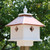 Wing & A Prayer Carriage Bird House, Hammered Copper Roof
Establish a bird haven in your garden with this Wing and A Prayer Carriage Bird House with Hammered Copper Colored Roof. This classic home blends traditional styling with modern elements for a lasting abode. The home has four separate apartments, offering housing for several birds at once. Vertical lines on the exterior create the appearance of paneling on the sides for a realistic feel. A ledge around the base of the item lends fledglings takeoff or perching room, and the hammered copper colored, PVC roof protects the abode from the elements. A large white finial tops the piece to complete the look. A copper colored metal predator guard surrounds each 1.5" diameter entrance hole, preventing other birds from enlarging the entry and overtaking the house. Constructed of solid PVC trimboard, this house is designed not to mildew, mold, or delaminate with exposure to the elements, and will remain stable for up to 25 years. Use the preinstalled mounting collar to connect this home to a 4" x 4" post (not included), bringing height to the abode. The white color of the PVC contrasts the copper tone on the PVC roof, for a stylish roost. Invite several birds to live in your yard with this Carriage Bird House with Hammered Copper Colored Roof. Made in the USA.
