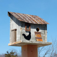 Bird In Hand Cumberland Chicken Coop Bird House
Enhance the avian theme in your backyard in a whimsical way with this Bird In Hand Cumberland Chicken Coop Bird House. The fantastic, reclaimed wood body forms an environmentally sound shelter, while its charming details bring a rustic motif to your yard in moments. Its rectangular frame and sloped metal roof form a classic chicken coop shape, and a black, plastic rooster silhouette on the front of the piece furthers the theme. A faux nest box occupies one side of the shelter, and a piece of metal forms a faux chicken ramp to complete the look. This ramp leads to the 1.125" diameter entrance hole, which allows wrens or chickadees to access the interior. The aged metal roof fully protects the nesting cavity from rain, and a ventilation gap beneath its overhang helps regulate the internal temperature. A few holes on the base of the home allow any captured water to drain. A metal panel covers the 2" cleanout hole on the back of the shelter, and the flat back makes the item simple to place against a wall or fence. For added display options, affix a mounting plate (not included) to the bottom platform and situate the unit on a post or pole. Crafted from reclaimed wood, this abode brings an environmentally friendly feel to the yard, while its aged white finish furthers the farming motif. Add poultry to the list of birds you see in your garden with this Cumberland Chicken Coop Bird House. Made in the USA.

Note: This product is handcrafted by the Amish using reclaimed and recycled wood. As such, each individual item may vary slightly.

Opening: 1.125" dia.
Dimensions: 10.25"W x 7"D x 9.75"H
Mounting: may be hung or post mounted
Construction: wood, metal