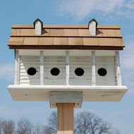 Bird In Hand Martinsburg Purple Martin Manor, 6 Room
Begin a martin colony in your garden by placing this Bird In Hand Martinsburg Purple Martin Manor in it. This detailed, wooden piece offers a rustic hint to your backyard, while providing six martin families a lasting shelter. Four 2" diameter openings line the front of this abode, while two additional entries on the top level offer more space for birds. The home's antique white body and tall, pitched roof help regulate the interior temperature of each nest, assisted by the reclaimed wood construction. This design reduces landfill waste, and lends extra charm to your garden. Lapped detailing on each side of the shelter enhances the realistic hint, and five columns along the front visually divide the piece. These columns also support the porch roof, overhanging each entry, and a significant base provides landing and perching spots. Holes on this base also allow any captured water to drain from the nests, and an integrated bracket here makes it simple to place the home on a wooden 4 x 4 post (not included). The roof lifts easily for nest checks and seasonal maintenance, and two faux dormers here add a classic look to the piece. The weathered finish lends dimension to your bird sanctuary, while the reclaimed wood body offers strength for many seasons. Offer martins a rustic retreat with this Martinsburg Purple Martin Manor. Made in the USA.

Note: This product is handcrafted by the Amish using reclaimed and recycled wood. As such, each individual item may vary slightly.

Openings: 2" dia.
Apartment Size: 6"L x 4"W x 5.5"H bottom units, 10"L x 6"W x 7"H top units
Dimensions: 24.25"L x 13.75"W x 18.25"H
Mounting: post mount
Construction: wood
Shipping Weight: 33 lbs