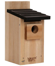 Nature's Way Cedar Traditional Bluebird House
Invite a bluebird family to roost in your yard by placing this Nature's Way Cedar Traditional Bluebird House in it. These melodious birds readily nest in manmade cavities, and this durable, cedar piece sports a bevy of features that keep the birds protected. A 1.5" diameter entry hole rests on the front of the shelter, surrounded by a significant, 1" thick piece of cedar. This cleverly extends the entry, forming a barrier which discourages squirrels and other predators from reaching into the nest cavity. A black, lapped roof overhangs this entry, protecting the nest from rain, and a gap beneath it helps ventilate the shelter. Routed lines slightly above the base hold a wire mesh screen, which acts as a nest lift to prevent blowfly infestations. The front panel raises upward to check the nest, and skerfs on the interior of this section help nestlings reach the hole when ready to exit. Attach this shelter to a post or pole using a mounting bracket, or affix its extended back panel to a fence or wall for a different look. The durable, cedar body provides hardiness and longevity to the item, as it naturally repels insects and rot, and will age to a striking gray hue over time. Turn your yard into a bird sanctuary with this Cedar Traditional Bluebird House. Three year warranty.

Opening: 1.5" dia.
Dimensions: 8"L x 5.5"W x 12"H
Mounting: pole or post mount
Construction: cedar, metal
Mfg. Warranty: 3 year warranty