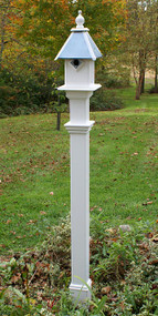 New England Decorative Mounting Post, White, 5'
Add a classic and dramatic display post to your garden using this New England White Decorative Mounting Post. This lasting vinyl post easily creates a lovely support for your existing bird house or feeder, thanks to its white body and stepped trim. Its 60" height places outdoor solar lights or bird feeders at a fantastic viewing height, while the included, 48" long, galvanized steel anchor ensures plenty of stability in your yard. This rod installs up to 24" into soil, and included screws attach the post to the internal collar for extra strength. The open top of the piece is perfect for showcasing items that accept a true 4" x 4" post, and the included molding adds a touch of elegance to your yard. The vinyl construction not only retains its vivid white color; it also cleans easily with a garden hose and will not peel, warp, fade, or yellow. Display an outdoor adornment in a classic and beautiful way with this White Decorative Mounting Post. Some assembly required.

Note: This description refers only to the New England Decorative Mounting Post. The house shown is not included.

Capacity: up to 35 lbs.
Overall Dimensions: 6.25"W x 6.25"D x 60"H
Mounting: place anchor in ground, slide post over anchor
Construction: vinyl