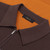 Orange zipped polo shirt, chocolate and white color-block
