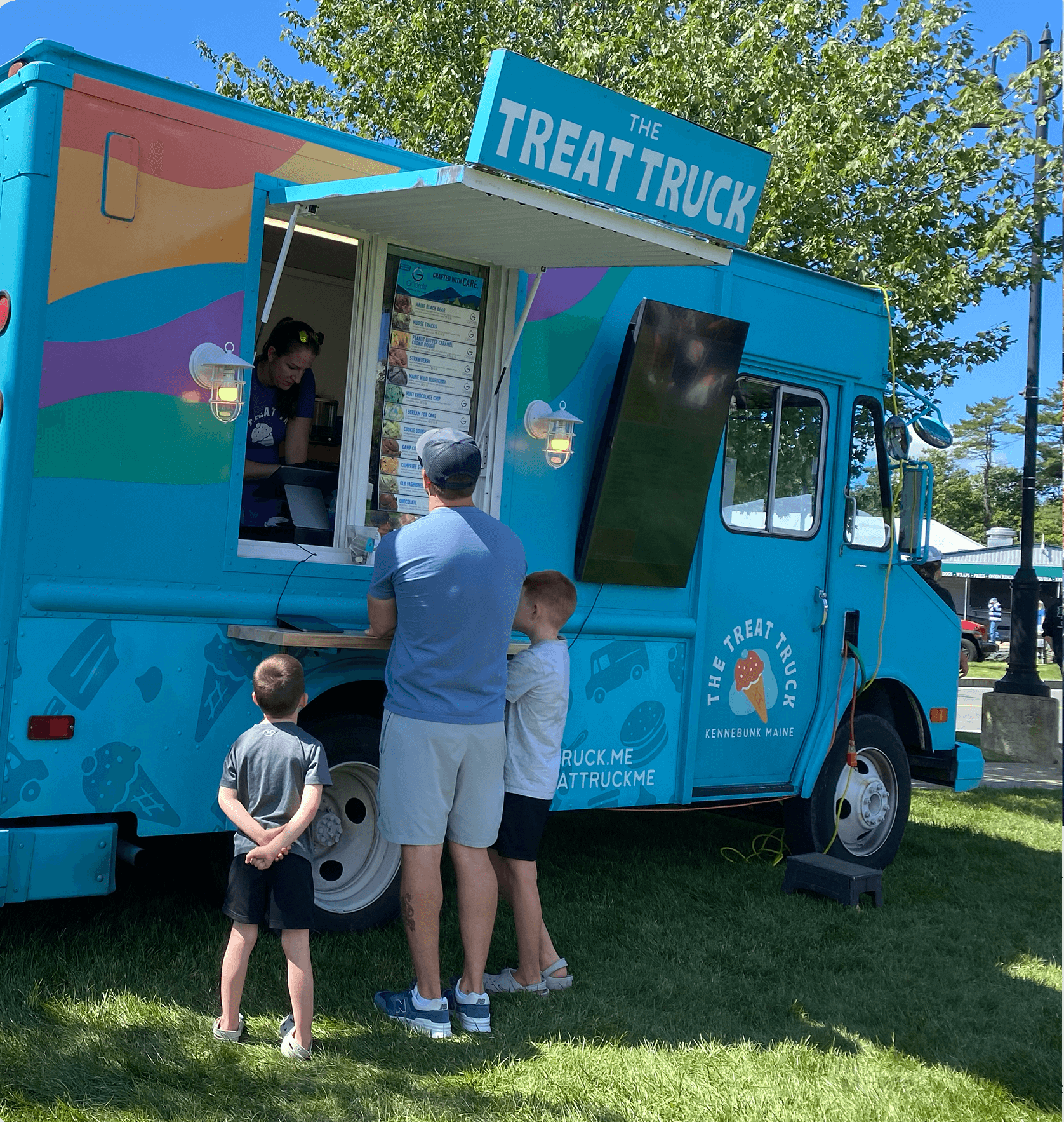 Colorful ice cream truck with treats and food samples
