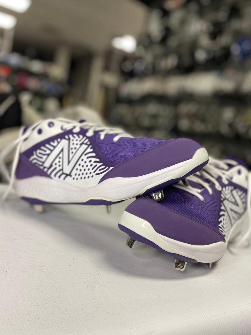 purple and white softball cleats