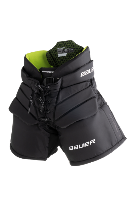 Vist Large View of Product Image Which is The BAUER PRODIGY Goal Pant features a new volume spec designed for optimal comfort and an appropriate fit for their size.


Key Features:
Volume Fit – An updated, streamlined fit sits higher on the hips to provide protection and mobility where it’s needed most.
Skate Lace Closure – Pro-inspired look with extra adjustability to handle growth spurts.
External Belt – Adjust the fit with an easy-to-access external belt.
Molded Curved Thigh – Block shots without missing a beat with added protection in the pant that doesn’t reduce mobility.
Stretch Legs – Elastic materials in the inner legs help you get more use out of the pants as
they start growing.