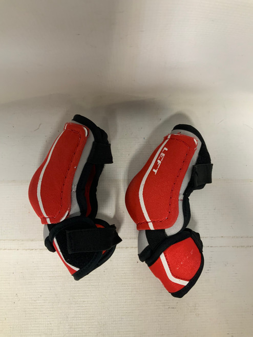 Vist Large View of Product Image Which is Used CCM U Junior Elbow Pads Red LG 11823-S000031801