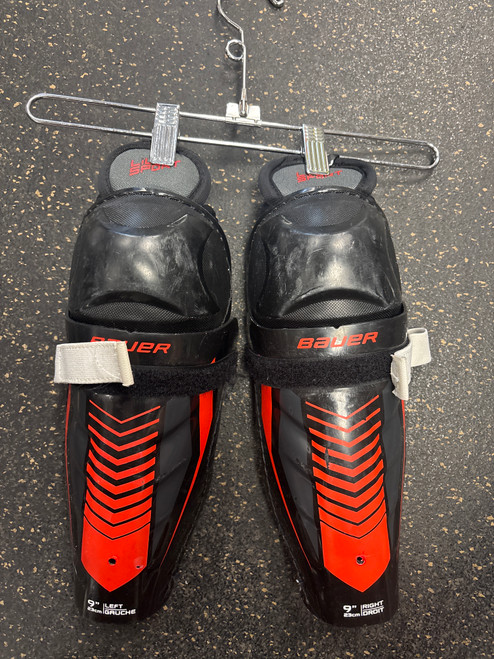 Vist Large View of Product Image Which is Used Bauer LIL SPORT Junior Shin Guards Black 9"