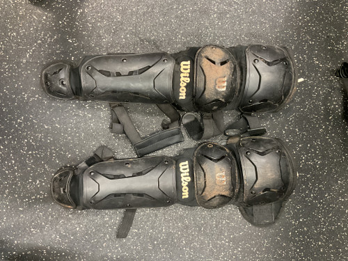 Vist Large View of Product Image Which is WILSON Catchers Leg Guards Black Youth