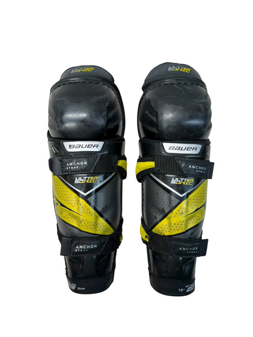 Vist Large View of Product Image Which is Used Bauer Ultra Sonic 10” Youth Hockey Shinguards - Black And Gold