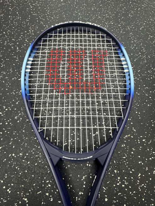 Vist Large View of Product Image Which is Used Wilson TOUR SLAM LITE Adult Tennis Racquet Navy Blue 4 3/8"