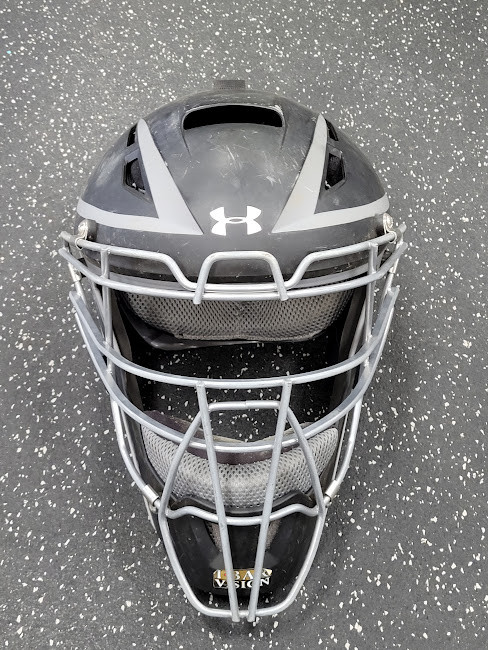 Vist Large View of Product Image Which is Used Under Armour UAHG3A-1 Catchers Helmet w/Mask Black LG
