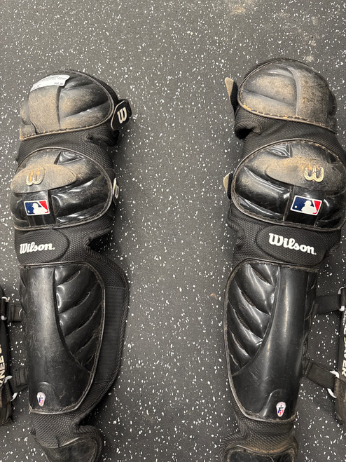 Vist Large View of Product Image Which is Used Wilson Catchers Leg Guards Black Junior