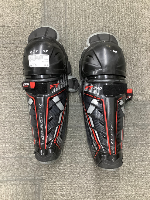 Vist Large View of Product Image Which is Used CCM FT390 Junior Shin Guards Black 11"