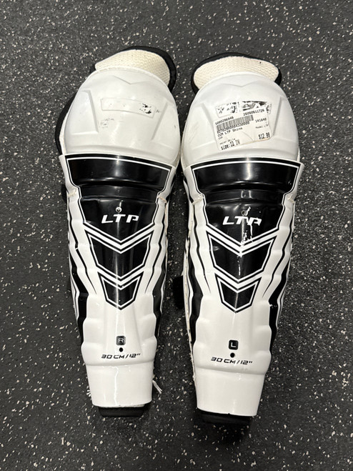 Vist Large View of Product Image Which is Used CCM LTP Junior Shin Guards White 12"