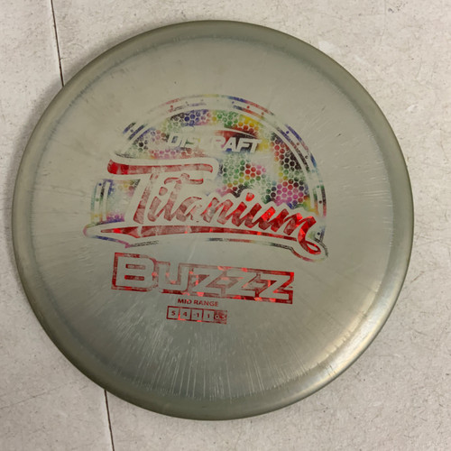 Vist Large View of Product Image Which is Used Discraft TITANIUM BUZZZ Disc Golf Mid Range Grey 176g