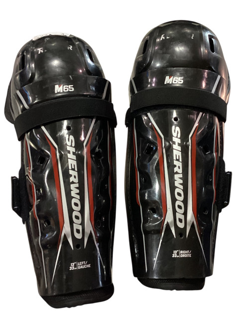 Vist Large View of Product Image Which is Used Sher-wood M65 Junior Shin Guards Black 13"