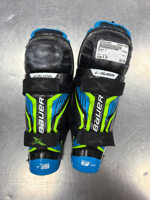 Vist Large View of Product Image Which is Used Bauer X Junior Shin Guards Black 9"