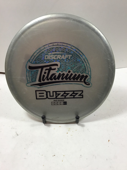 Vist Large View of Product Image Which is Used Discraft TITANIUM BUZZZ Disc Golf Mid Range Grey 180g