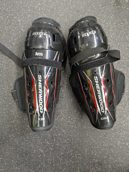 Vist Large View of Product Image Which is Used Sher-wood M65 Junior Shin Guards Black 12"
