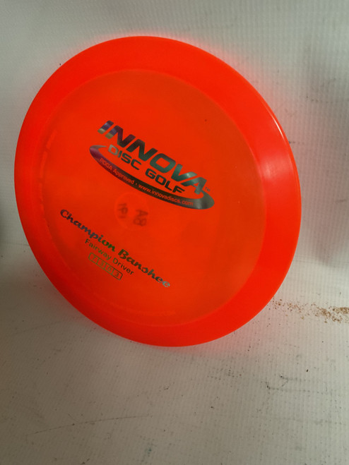 Vist Large View of Product Image Which is Used Innova CHAMPION BANSHEE Disc Golf Driver Orange