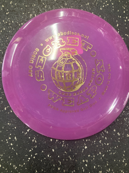 Vist Large View of Product Image Which is Used ABC SECRET WEAPON Disc Golf Driver Purple