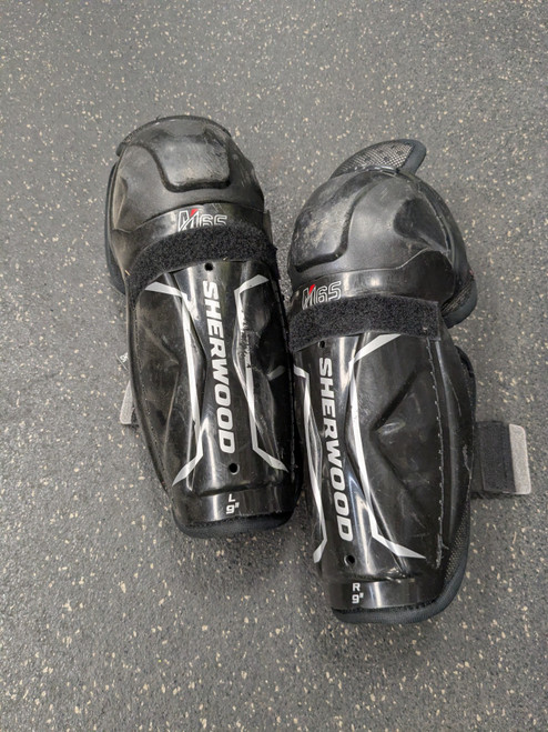Vist Large View of Product Image Which is Used Sher-wood M65 Youth Shin Guards Black 9"
