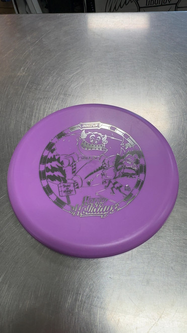 Vist Large View of Product Image Which is Used Innova HAPPY HOLIDAYS XT INVADER Disc Golf Putter Purple