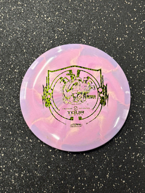 Vist Large View of Product Image Which is Used Discraft TOUR SERIES ZOMBEE 2021 Disc Golf Mid Range Pink