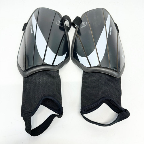 Vist Large View of Product Image Which is Used Nike CHARGE Soccer Shin Guards Adult Black LG