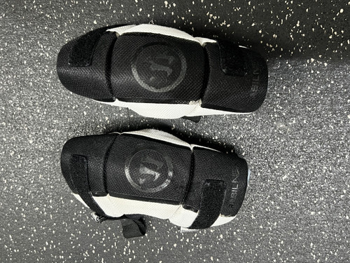 Vist Large View of Product Image Which is Used Warrior RABIL NEXT Lacrosse Arm Pads/Guards Black And White SM