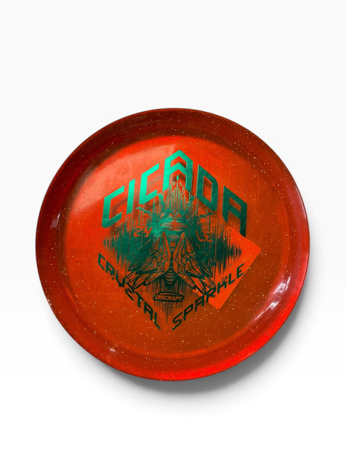 Vist Large View of Product Image Which is Used Discraft CRYZTAL SPARKLE CICADA 24 LE Disc Golf Driver Orange 171g